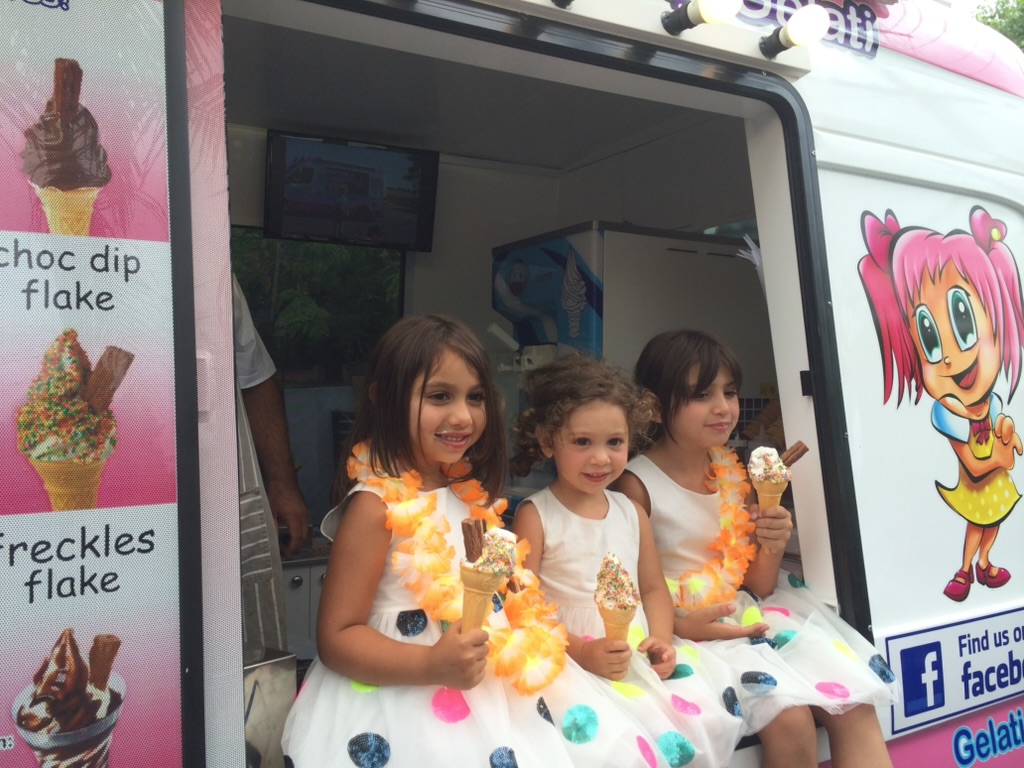 Children enjoying ice creams beside a Mr Softy van